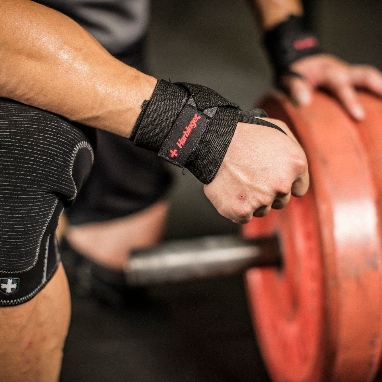 Lifter wearing Harbinger Pro thumb loop wrist wraps during a set